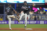 Miami Marlins shortstop Vidal Brujan (17) and left fielder Nick Gordon celebrate after the Marlins beat the New York Mets 8-0, during a baseball game, Friday, May 17, 2024, in Miami. (AP Photo/Wilfredo Lee)