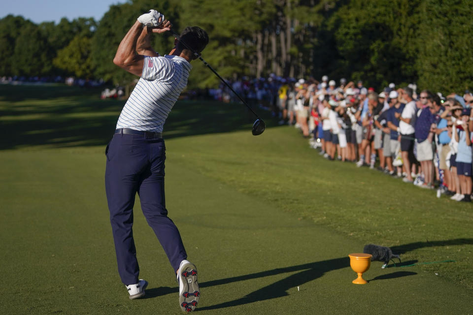 Billy Horschel hiots off the 18th green during their fourball match at the Presidents Cup golf tournament at the Quail Hollow Club, Friday, Sept. 23, 2022, in Charlotte, N.C. (AP Photo/Julio Cortez)