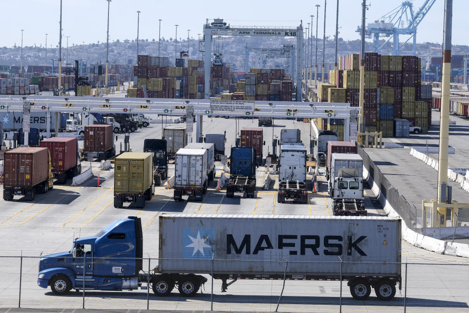 Cargo container trucks wait in line to enter AMP Terminals at the Port of Los Angeles, Wednesday, Oct. 20, 2021 in San Pedro, Calif. California Gov. Gavin Newsom on Wednesday issued an order that aims to ease bottlenecks at the ports of Los Angeles and Long Beach that have spilled over into neighborhoods where cargo trucks are clogging residential streets. (AP Photo/Ringo H.W. Chiu)