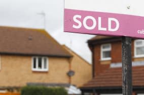 File photo dated 02/10/2012 of a general view of an estate agent's 'Sold' sign outside a property. House prices surged by 7.5% annually in December but fell back month-on-month for the first time in almost a year, Halifax has reported.  PRESS ASSOCIATION Photo. Issue date: Wednesday January 8, 2014. The year-on-year increase was close to a 7.7% rise recorded in November, which was the highest annual lift seen in six years.  See PA story ECONOMY House. Photo credit should read: Chris Ison/PA Wire