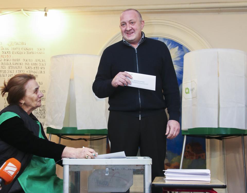 Georgian President Giorgi Margvelashvili prepares to cast his ballot at a polling station during presidential election in Tbilisi, Georgia, Sunday, Oct. 28, 2018. Sunday's election will be the last time residents of the former Soviet republic of Georgia get to cast a ballot for president, that's if any of the 25 candidates gets an absolute majority. (Leli Blagonravova, Presidential Press Service Pool Photo via AP)