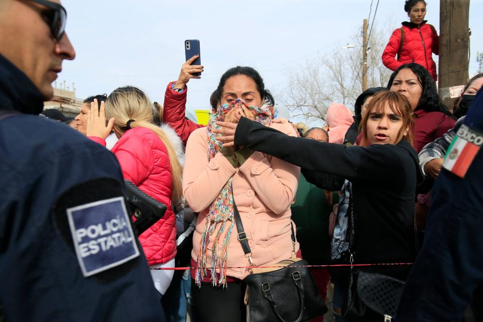 Relatives of prisoners and employees at the Cereso No. 3 state prison in Juárez break into tears awaiting information about loved ones after an escape Sunday morning, Jan. 1, 2023.. Ten guards and four prisoners died and 24 prisoners escaped.