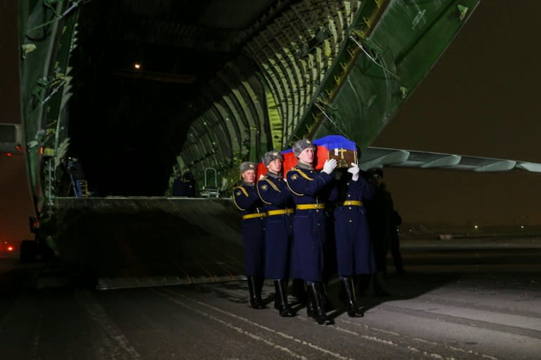 Russian honour guards carry the coffin of pilot Oleg Peshkov out of a plane at Chkalovsky military airport outside Moscow, on November 30, 2015