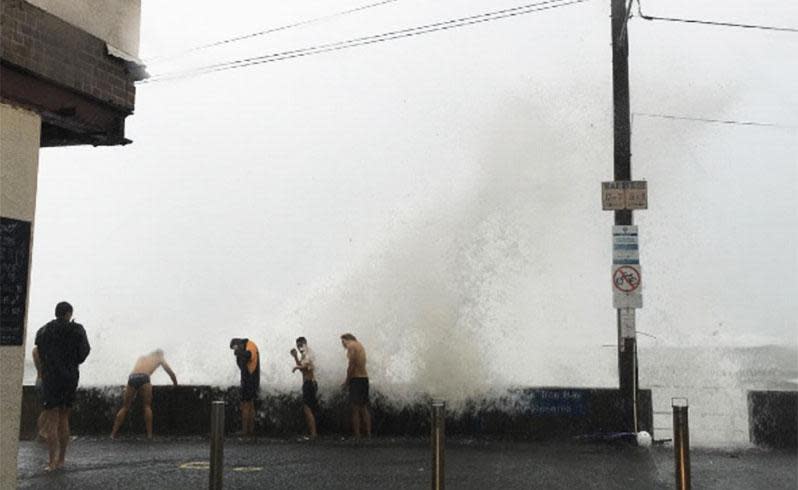 Some made the best of the situation by standing near the ocean's edge and copping the salty spray. Photo: Brooke Garrett/Instagram