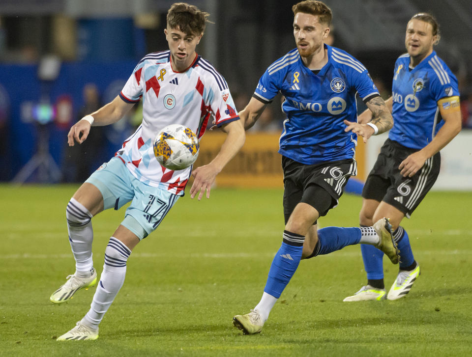 CF Montreal's Joel Waterman (16) rushes in from behind Chicago Fire's Brian Gutierrez (17) to disrupt his advance during the first half of an MLS soccer match in Montreal, Saturday, Sept. 16, 2023. (Peter McCabe/The Canadian Press via AP)