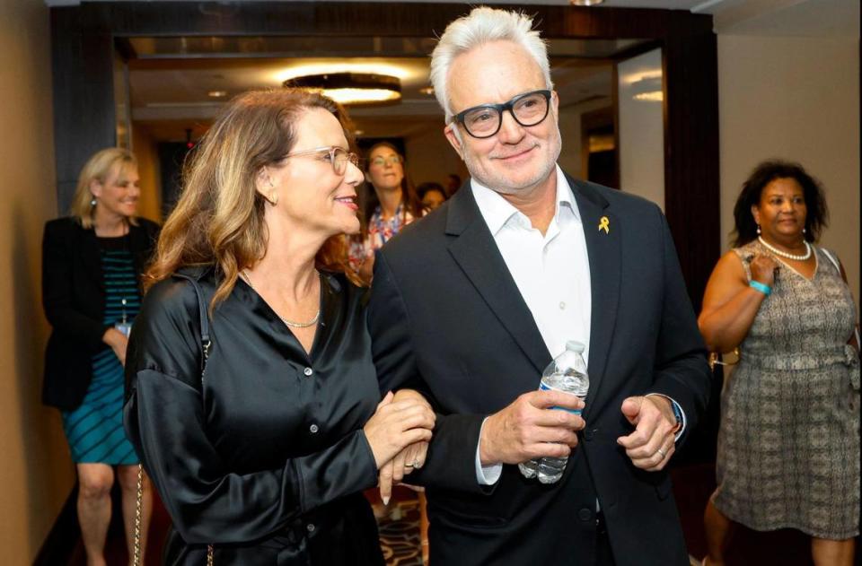 Actress Amy Landecker and actor/producer Bradley Whitford walk down a hall as they attend the Florida Democratic Party’s annual Leadership Blue Weekend at the Fontainebleau Hotel in Miami Beach, Florida, on Saturday, July 8, 2023.