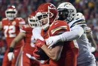 Kansas City Chiefs tight end Travis Kelce (87) is tackled by Los Angeles Chargers linebacker Jatavis Brown (57) during the first half of an NFL football game in Kansas City, Mo., Thursday, Dec. 13, 2018. (AP Photo/Ed Zurga)