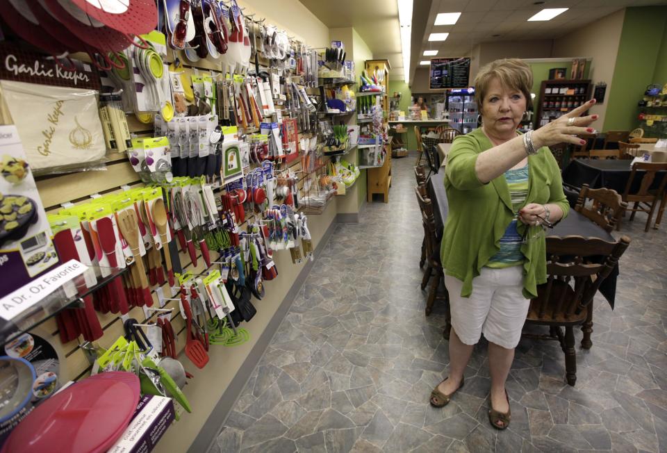 In this Tuesday, June 19, 2012 photo, Alice Simons talks about the many items she has on display in one of her three stores in Carroll, Iowa. Mitt Romney’s private sector resume has impressed Simons. "I do think he has a little more business sense than Obama does," she says. "The one thing that really bugs me is people criticize Romney for having money. ... I just want to see successful people. ... I guess what I’m saying if they have made their money in private business, why wouldn’t we want somebody that has that sense and know-how?” (AP Photo/Charlie Neibergall)