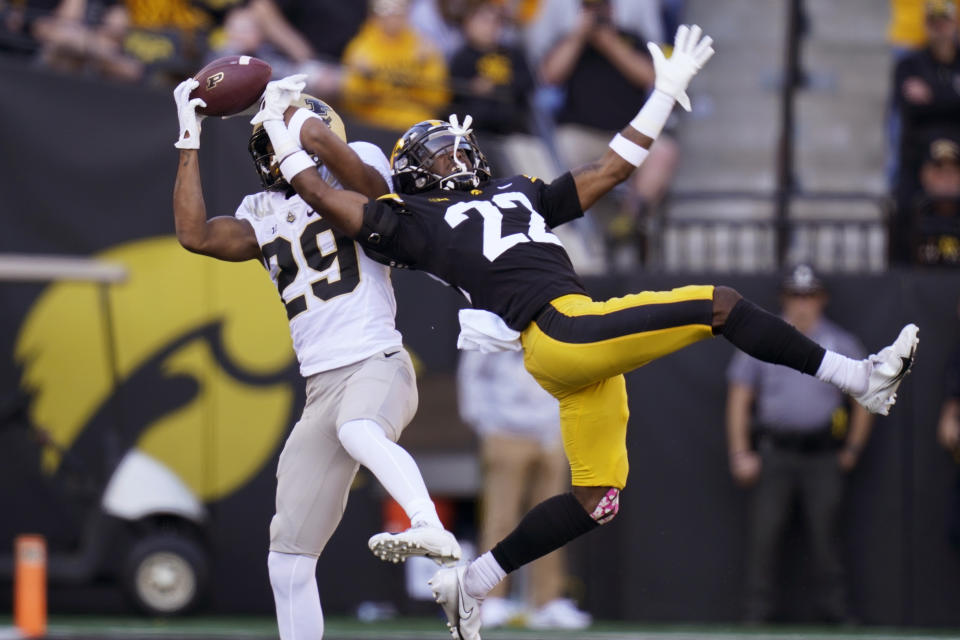 Purdue wide receiver Broc Thompson (29) catches a pass over Iowa defensive back Terry Roberts (22) during the first half of an NCAA college football game, Saturday, Oct. 16, 2021, in Iowa City, Iowa. (AP Photo/Charlie Neibergall)