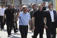 United Nations Secretary General Antonio Guterres waves as he visits the Odesa Sea Port, in Odesa, Ukraine, Friday, Aug. 19, 2022. (AP Photo/Kostiantyn Liberov)