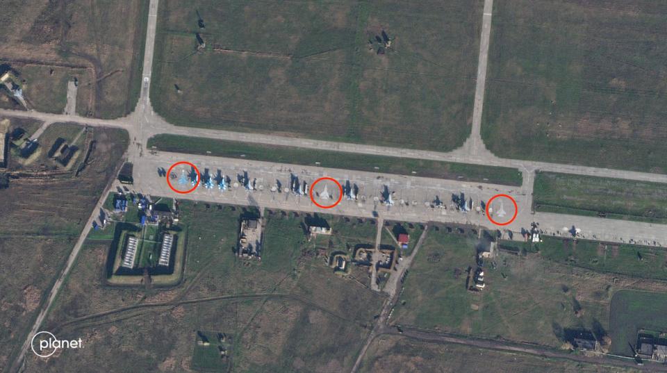 A satellite image with red circles highlighting painted aircraft.