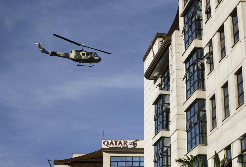 A Kenya Air Force helicopter flies over a hotel complex in Nairobi, Kenya Tuesday, Jan. 15, 2019. Terrorists attacked an upscale hotel complex in Kenya's capital Tuesday, sending people fleeing in panic as explosions and heavy gunfire reverberated through the neighborhood. (AP Photo/Ben Curtis)