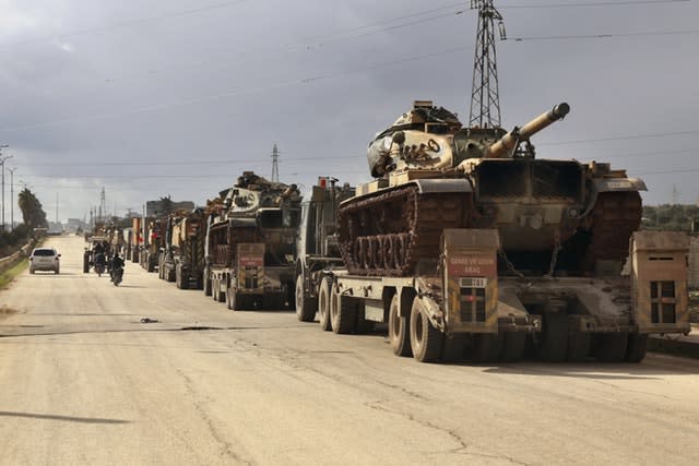 A Turkish military convoy drives through the village of Binnish in Idlib province, Syria