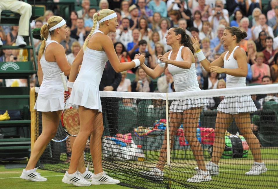 Italy's Sara Errani (R) and Roberta Vinci (2nd R) shake hands with Hungary's Timea Babos (L) and France's Kristina Mladenovic (2nd L) after the formers' won their women's doubles final match on day twelve of the 2014 Wimbledon Championships (AFP via Getty Images)