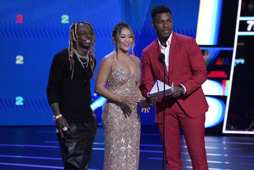 Lil Wayne, from left, gymnast Sunisa Lee and John Boyega present the award for best team at the ESPY Awards on Wednesday, July 20, 2022, at the Dolby Theatre in Los Angeles. (AP Photo/Mark Terrill)