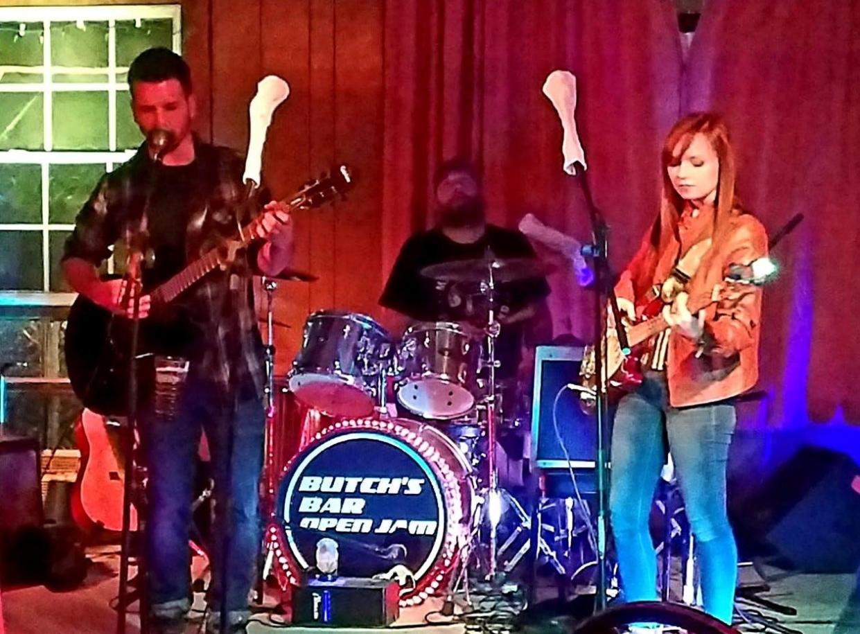 Local musicians Hunter Gatherer, Jamey Clark and Brittany Hildebrandt perform during a Wednesday night open jam at Butch's Bar. Clark was a founder and organizer of the sessions which ran every Wednesday for more than seven years until Butch's was destroyed in a Feb. 22 fire.