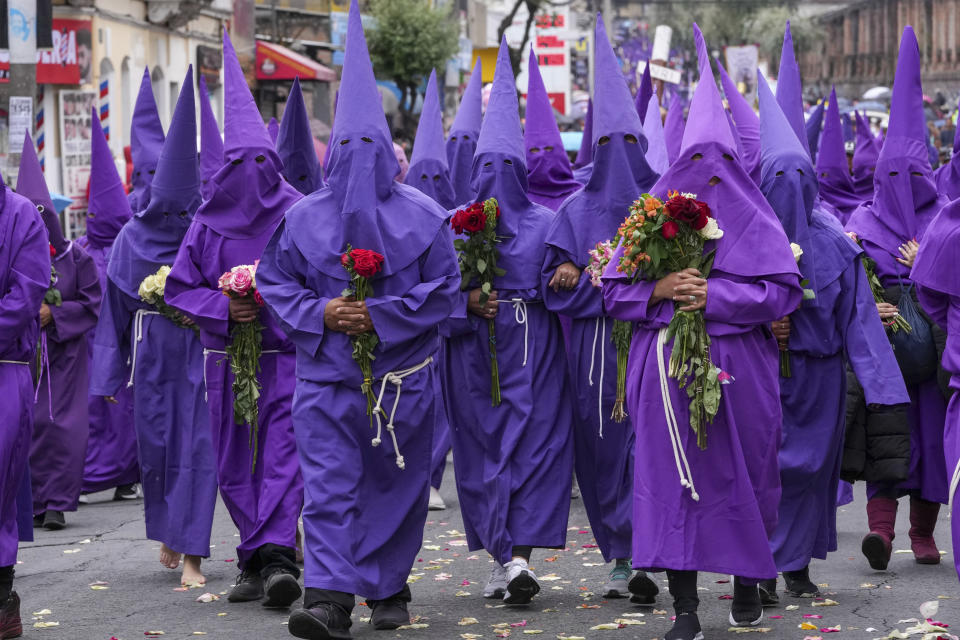 Penitents known as cucuruchos carry flower bouquets during the Jesus the Almighty Good Friday procession, as part of Holy Week celebrations, in Quito, Ecuador, Friday, March 29, 2024. Holy Week commemorates the last week of Jesus Christ’s earthly life which culminates with his crucifixion on Good Friday and his resurrection on Easter Sunday. (AP Photo/Dolores Ochoa)