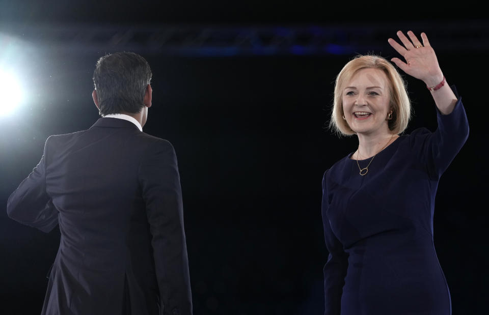 FILE - Liz Truss, right, waves, and Rishi Sunak stands next to her on stage after a Conservative leadership election hustings at Wembley Arena in London, Wednesday, Aug. 31, 2022. Britain's new leader, Liz Truss, is the child of left-wing parents who grew up to be an admirer of Conservative Prime Minister Margaret Thatcher. Now she is taking the helm as prime minister herself, with a Thatcherite zeal to transform the U.K. One colleague who has known Truss since university says she is “a radical” who wants to “roll back the intervention of the state” in people’s lives, just as Thatcher once did. (AP Photo/Kirsty Wigglesworth, File)