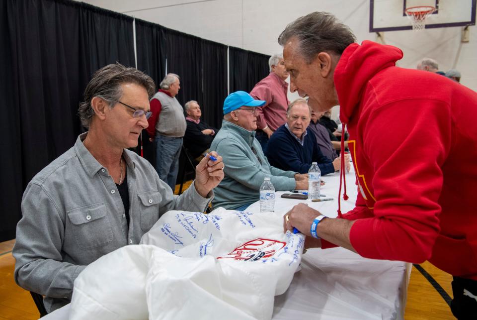 Don Mattingly looks over a jacket before signing it for Scott Garcia during the 23rd annual Tri-State Hot Stove League’s Night of Memories at the  University of Evansville’s Carson Center Saturday, Jan. 21, 2023. 