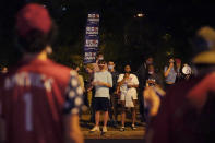 Supporters of former Vice President Joe Biden yell across the street at supporters of President Donald Trump in front of Belmont University during the second presidential debate Thursday, Oct. 22, 2020, in Nashville, Tenn. The debate was held in the Belmont basketball arena and event center. (AP Photo/Mark Humphrey)