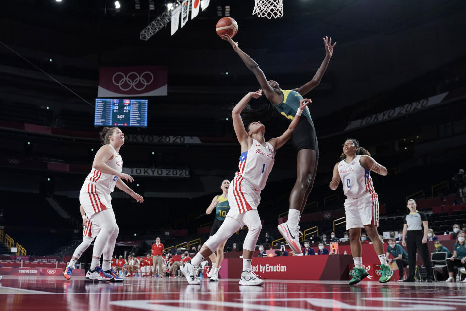 Australia's Ezi Magbegor, second from right, leaps over Puerto Rico's Tayra Melendez (1) to grab a rebound during a women's basketball game at the 2020 Summer Olympics, Monday, Aug. 2, 2021, in Saitama, Japan. (AP Photo/Eric Gay)