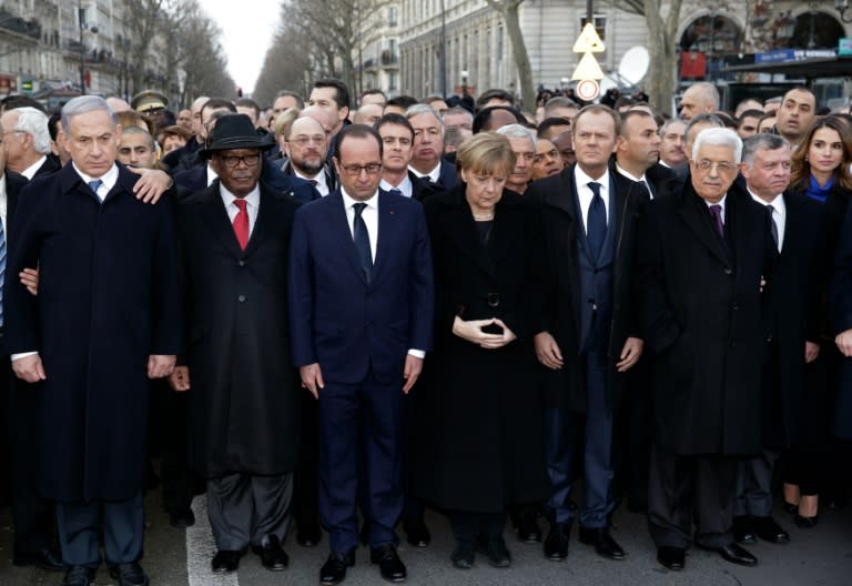 French President Francois Hollande observes a minute of silence surrounded by heads of state after the Charlie Hebdo attack