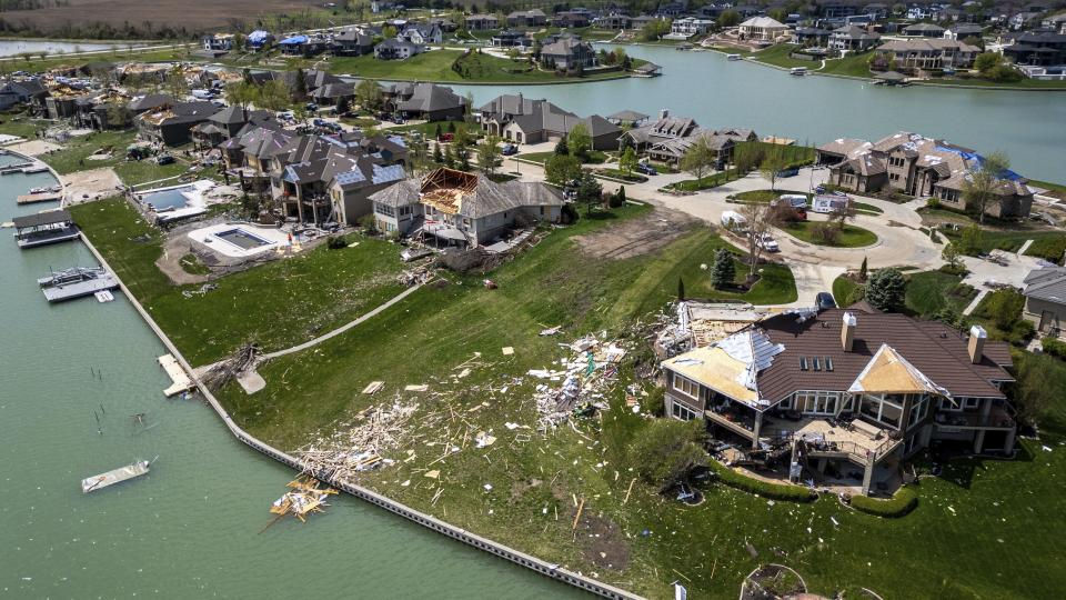 Damaged homes are seen after a tornado hit the Newport Landing neighborhood in Bennington, Neb., Saturday, April 27, 2024. Dozens of reported tornadoes wreaked havoc Friday in the Midwest. (Chris Machian/Omaha World-Herald via AP)