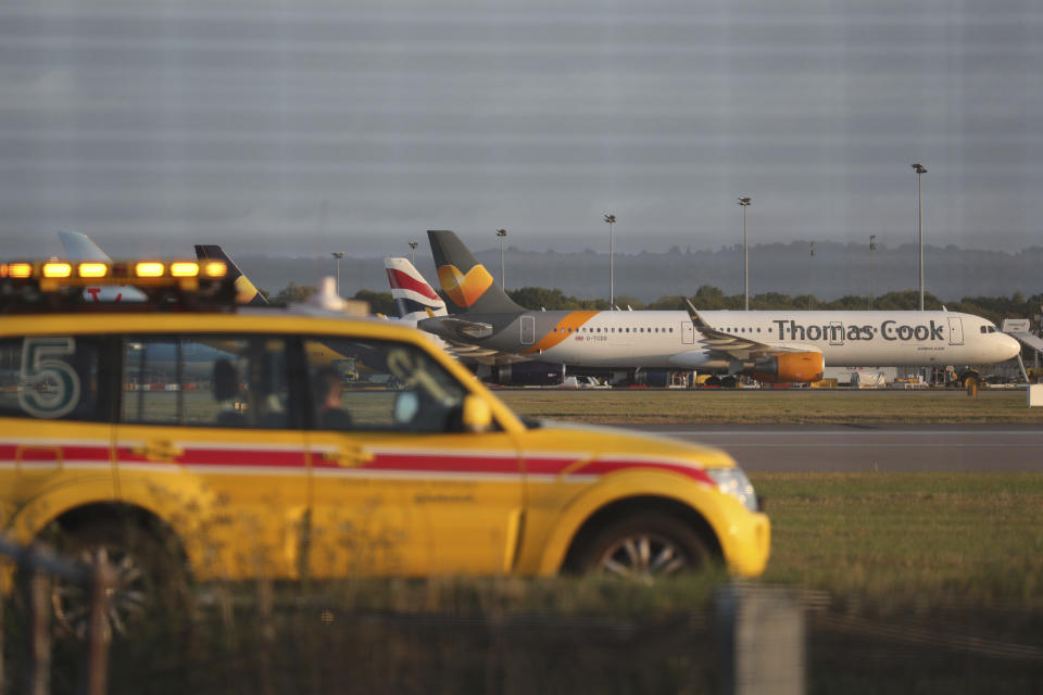 A Thomas Cook plane on the tarmac at Gatwick Airport in Sussex, England Monday Sept. 23, 2019. British tour company Thomas Cook collapsed early Monday after failing to secure emergency funding, leaving tens of thousands of vacationers stranded abroad. (Steve Parsons/PA via AP)