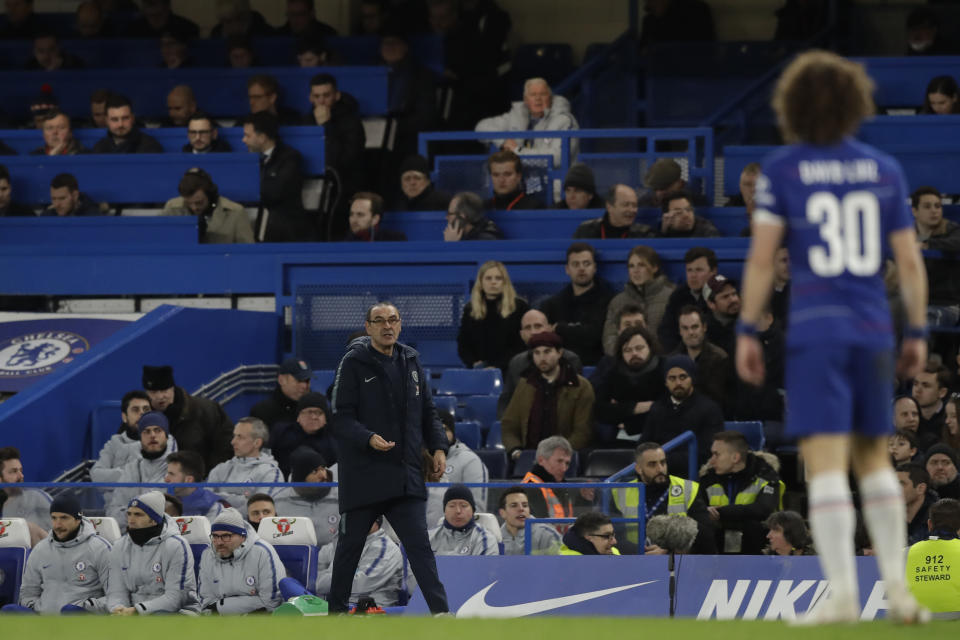 Chelsea head coach Maurizio Sarri gives instructions to David Luiz from the side line during the English FA Cup fifth round soccer match between Chelsea and Manchester United at Stamford Bridge stadium in London, Monday, Feb. 18, 2019. (AP Photo/Matt Dunham)