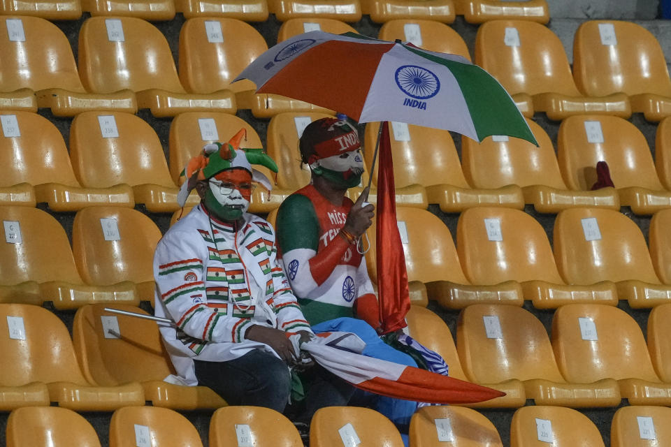 Indian cricket fans wait as the play is interrupted by rain during the Asia Cup cricket match between India and Nepal in Pallekele, Sri Lanka on Monday, Sep. 4. (AP Photo/Eranga Jayawardena)