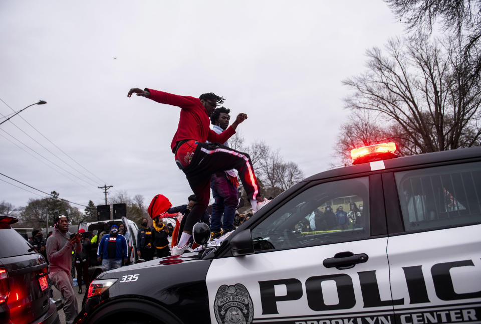 Image: A man stomps the windshield of a police cruiser as people protest after Brooklyn Center police shot and killed Daunte Wright during a traffic stop (Stephen Maturen / Getty Images)