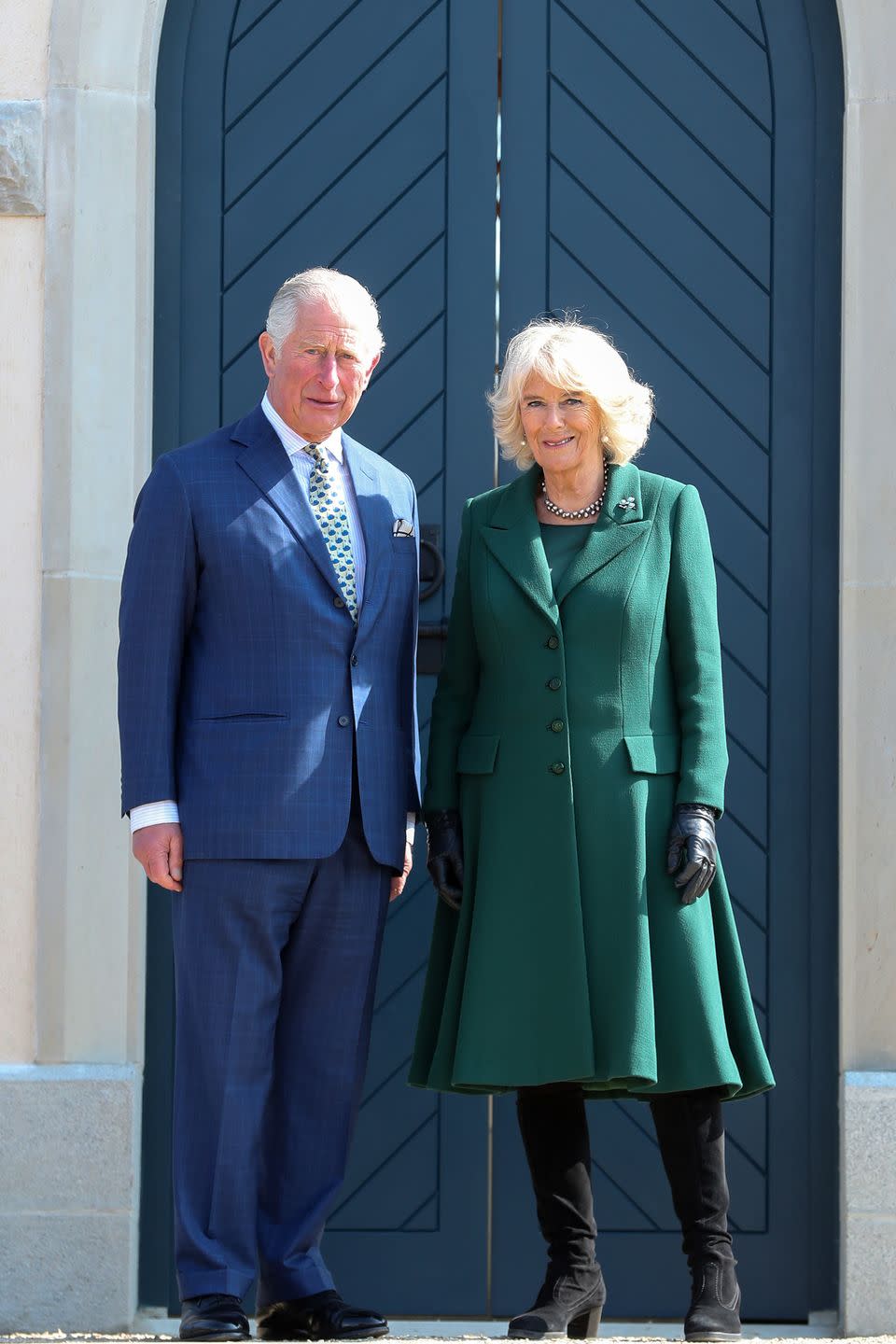 <p>Camilla wore a green coat dress for her <a href="https://www.townandcountrymag.com/society/tradition/a27088939/prince-charles-camilla-wedding-anniverary-northern-ireland/" rel="nofollow noopener" target="_blank" data-ylk="slk:trip to Northern Ireland with Prince Charles;elm:context_link;itc:0;sec:content-canvas" class="link ">trip to Northern Ireland with Prince Charles</a>. The royal topped off the look with black boots and gloves, pearl drop earrings, a choker necklace of black pearls, and an emerald and diamond shamrock brooch. </p>