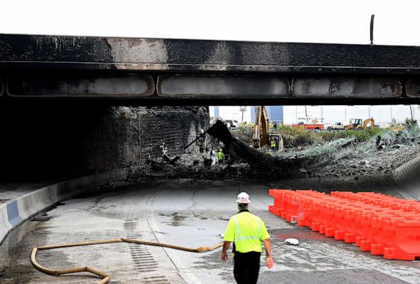 PHOTO: Workers inspect and clear debris from a section of the bridge that collapsed on Interstate 95 after an oil tanker explosion on June 12, 2023 in Philadelphia. (Mark Makela/Getty Images)