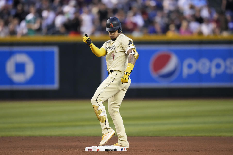 Arizona Diamondbacks' Ketel Marte celebrates after his double against the Los Angeles Dodgers during the first inning of a baseball game Friday, April 7, 2023, in Phoenix. (AP Photo/Ross D. Franklin)