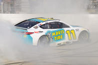 Denny Hamlin celebrates with a burnout after winning a NASCAR Cup Series auto race at Dover Motor Speedway, Sunday, April 28, 2024, in Dover, Del. (AP Photo/Derik Hamilton)