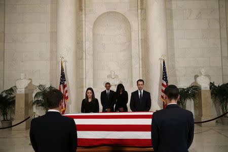 U.S. President Barack Obama (C-L) and first lady Michelle Obama (C-R) visit the casket of late U.S. Supreme Court Justice Antonin Scalia in the Supreme Court's Great Hall in Washington February 19, 2016. REUTERS/Kevin Lamarque