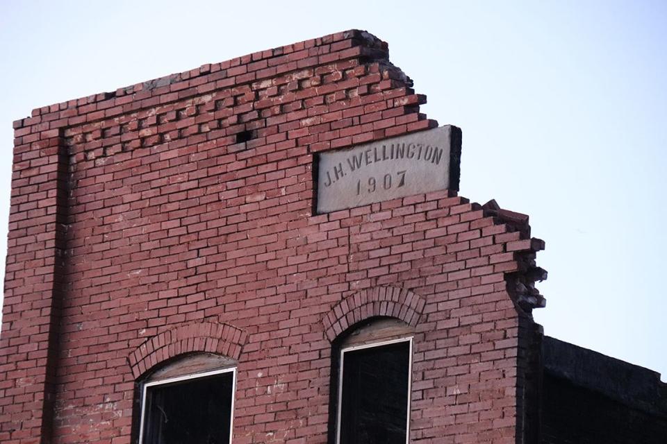 The building's marker at 524 E. Main read J.H. Wellington —1907.