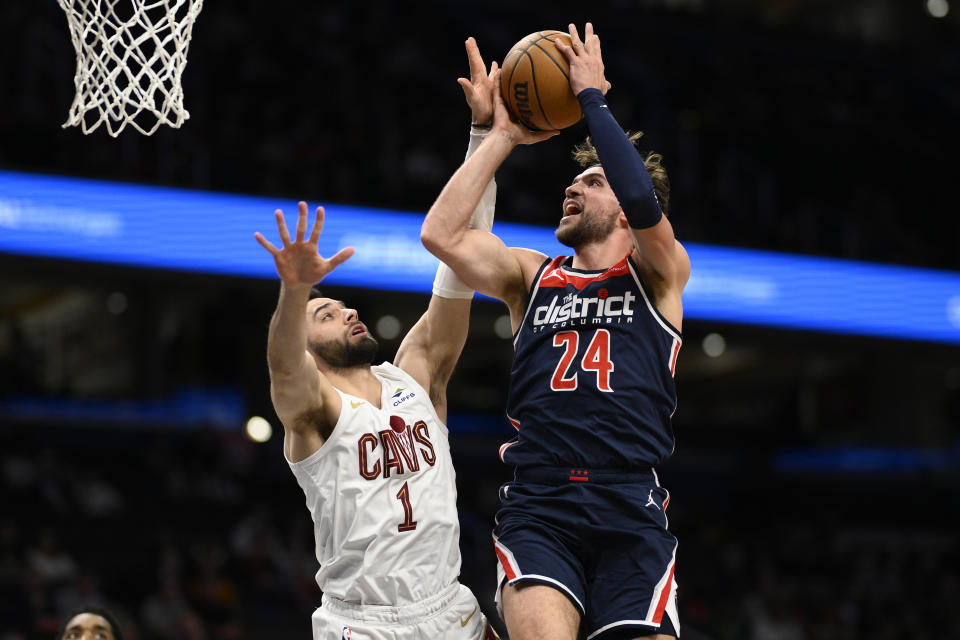 Washington Wizards forward Corey Kispert (24) goes to the basket against Cleveland Cavaliers guard Max Strus (1) during the first half of an NBA basketball game Wednesday, Feb 7, 2024, in Washington. (AP Photo/Nick Wass)