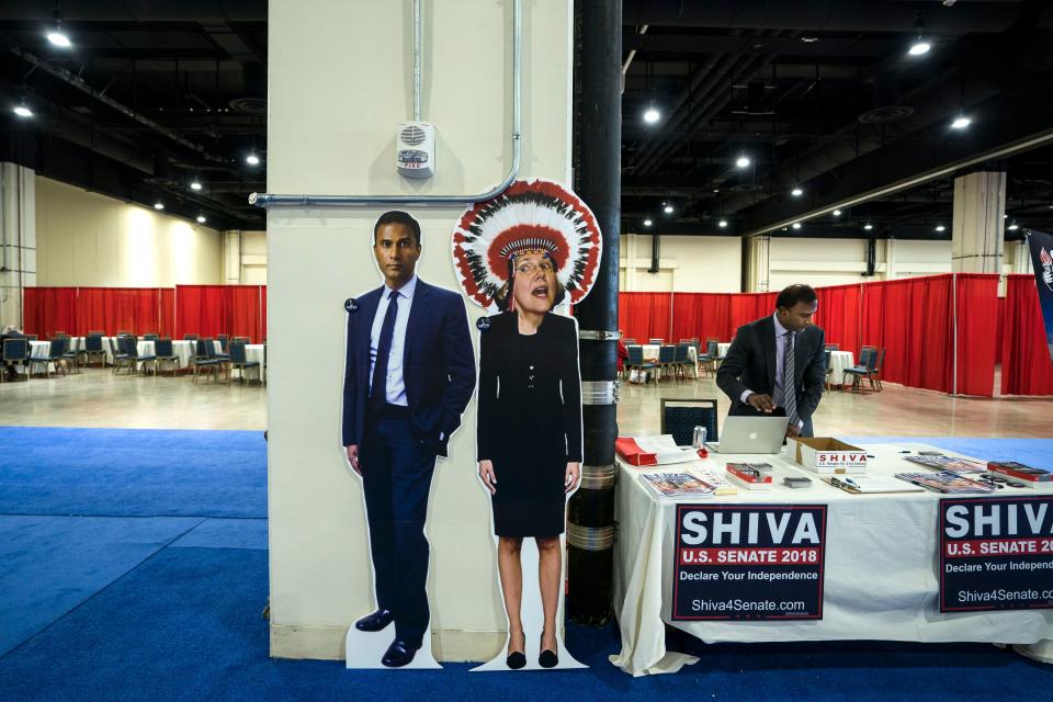 <p>Shiva Ayyadurai (R), who is running for a US Senate seat in Massachusetts, stands behind his booth at the 45th annual Conservative Political Action Conference (CPAC) at the Gaylord National Resort & Convention Center in National Harbor, Md., Feb. 22, 2018. (Photo: Jim Lo Scalzo/EPA-EFE/REX/Shutterstock) </p>