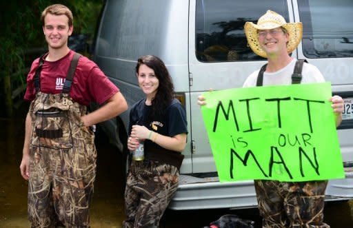 Storm-affected residents from Hurricane Isaac show their support for Republican White House hopeful Mitt Romney who visited LaFitte, outside of New Orleans, on August 31. Romney has toured storm-ravaged New Orleans in a bid to burnish his presidential credentials ahead of his November battle with Barack Obama