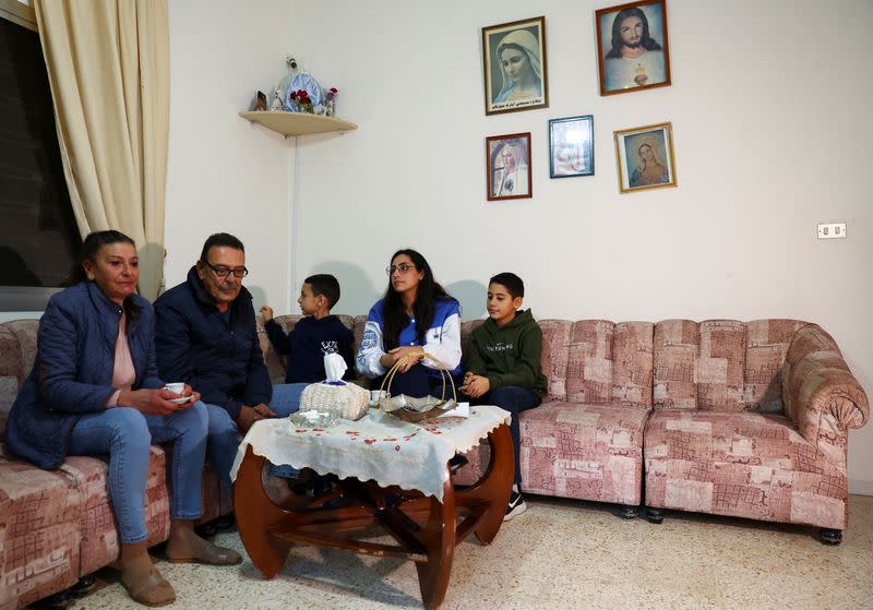 Rose Rustom sits with her family members at her brother-in-law's home in Sidon