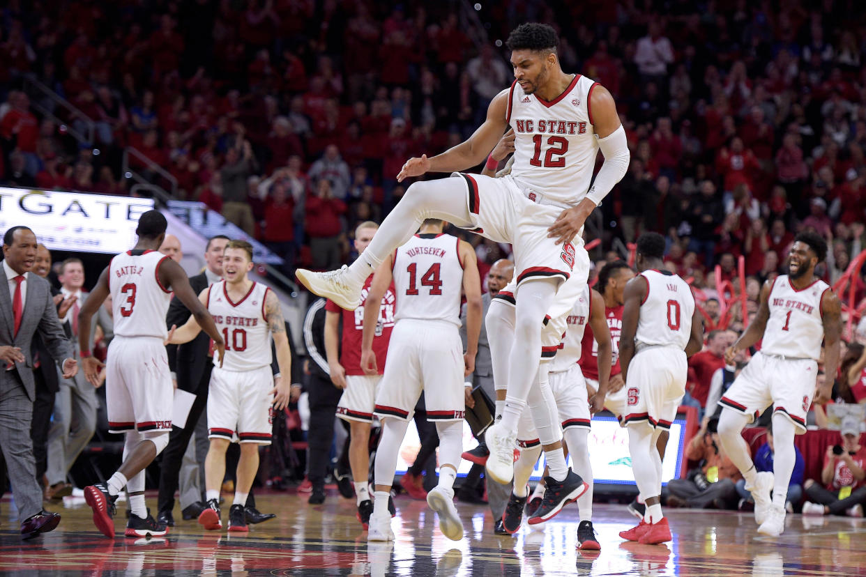 Allerik Freeman #12 of the North Carolina State Wolfpack celebrates with teammates following a play against the Duke Blue Devils at PNC Arena on January 6, 2018 in Raleigh, North Carolina. (Getty Images)