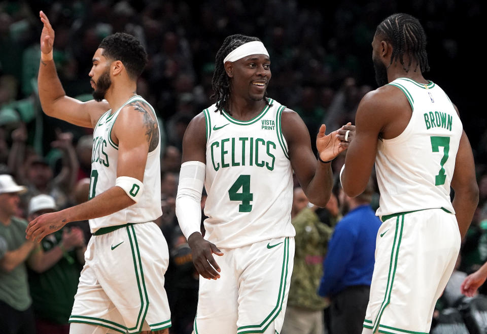 Boston, MA - April 21: Boston Celtics forward Jayson Tatum, guard Jrue Holiday and guard Jaylen Brown celebrate victory.  (Photo by Barry Chin/The Boston Globe via Getty Images)