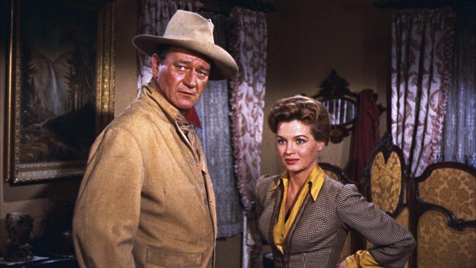 This image released by Warner Bros. Entertainment shows John Wayne as Sheriff John T. Chance, left, and Angie Dickinson as Feathers in a scene from "Rio Bravo." Dickinson is helping to kick off this year's TCM Classic Film Festival this week in Hollywood with a screening and a discussion of the 1959 classic. (Warner Bros. Entertainment via AP)