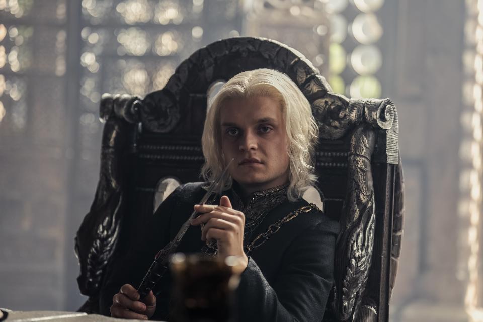 A young man with silvery blond hair sitting in an ornate chair; Tom Glynn-Carney in 'House of the Dragon'