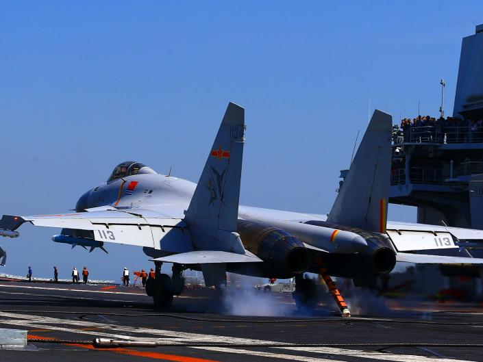 J15 fighter jet lands on China's only operational aircraft carrier, the Liaoning, during an exercise at sea.