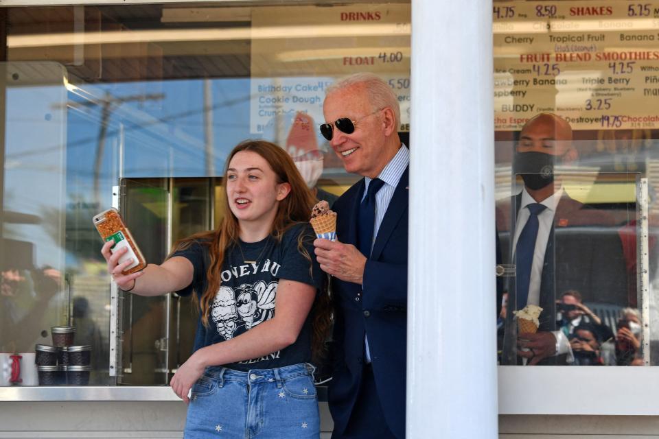 President Joe Biden poses for a photo with a girl after getting an ice cream at Honey Hut Ice Cream in Cleveland, Ohio, on May 27, 2021.