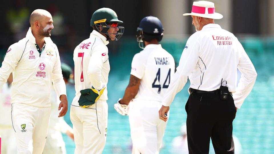 Tim Paine and Nathan Lyon, pictured here questioning umpire Paul Wilson.