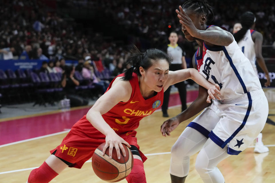 China's Wang Siyu attempts to push past United States' Jewell Loyd during their game at the women's Basketball World Cup in Sydney, Australia, Saturday, Sept. 24, 2022. (AP Photo/Mark Baker)