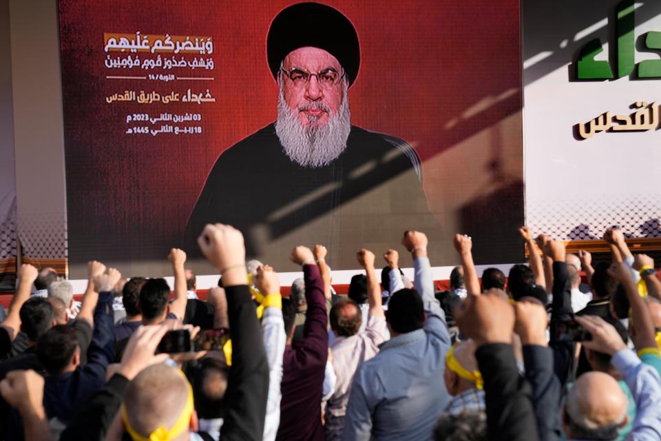 Supporters of the Iranian-backed Hezbollah group raise their fists and cheer as Hezbollah leader Sayyed speaks (Copyright 2023 The Associated Press. All right reserved)